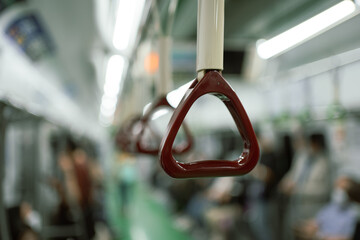 Brown train handle on subway in Korea.
