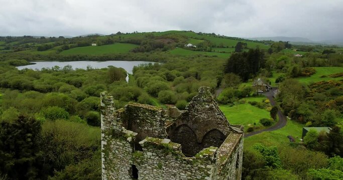 Drone 4K Reveal of Ballinacarriga Castle  a 16th-century tower house located in the village of Ballinacarriga Co Cork Ireland