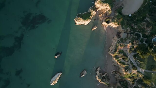 Top down view of the jagged coastline at Praia dos Tr&ecirc;s Irm&atilde;os in Portugal. Drone shot