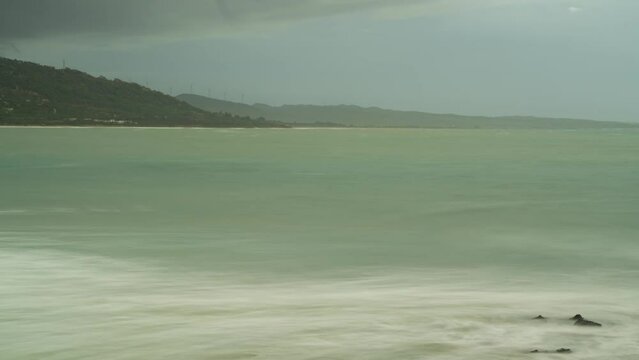 Stormy clouds flowing over sandy beach of Spain, time lapse view