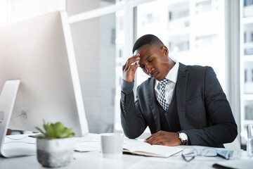 Black man in business, headache and stress in workplace with corporate burnout, depression and pain in office. Male professional at desk, migraine and tired, overworked with anxiety and work crisis