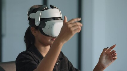 Close up businesswomen executive using virtual reality headset in office. Woman testing VR goggles or glasses for working virtual project .VR technology and business concept - Powered by Adobe