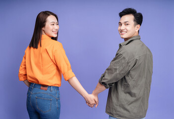 Photo of young Asian couple on background