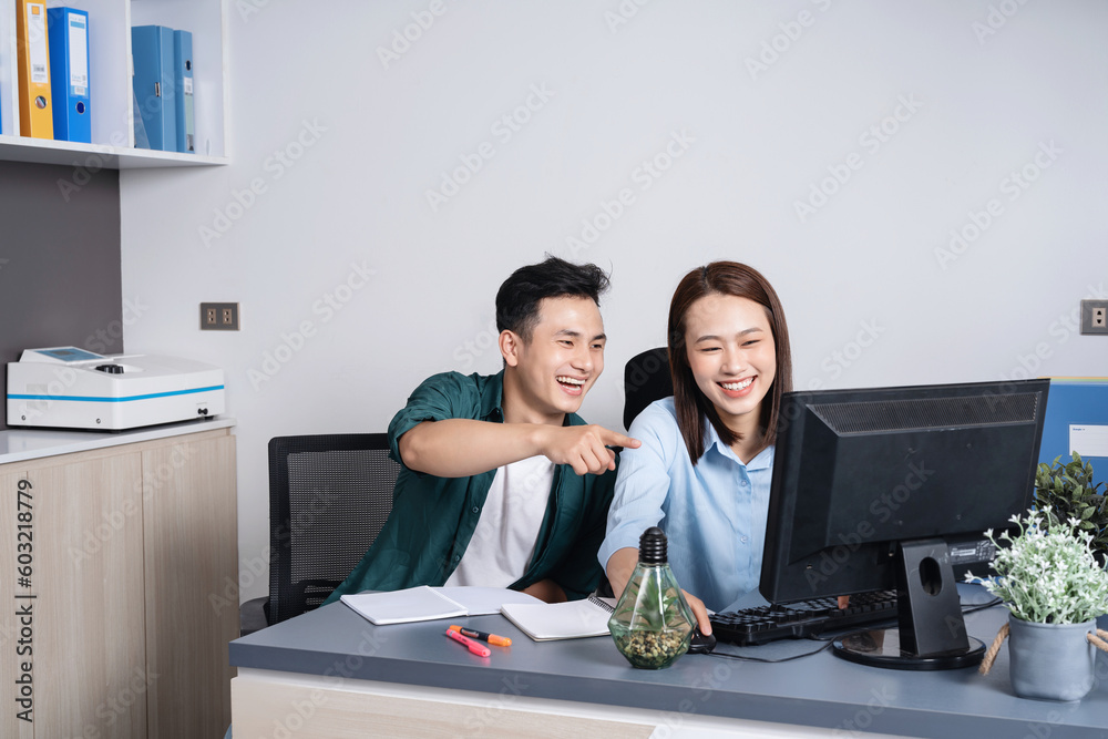 Wall mural photo of two young asian business person working at office