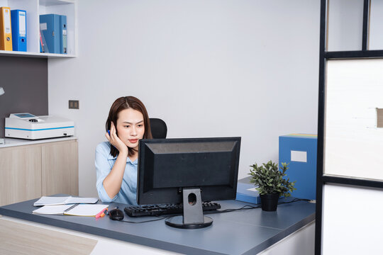 Photo of young Asian businesswoman working at office