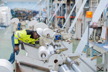 american engineer Wear uniforms and helmets. Looking to inspect the operation of machines that are working for steel and plastic manufacturing business. in large industrial plants