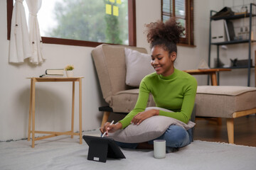 Cute young woman using tablet entertainment relaxing at home. Beautiful young black women using tablet computer at home.