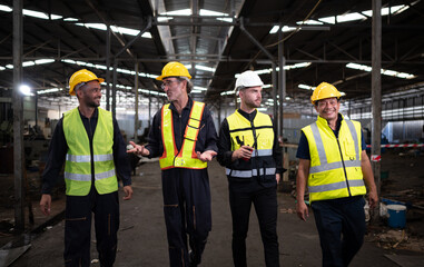 Portrait of team of engineers and technicians that is ready for repairing old machinery to return to normal operation in the company's old machinery warehouse