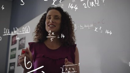 Animation of maths calculations over smiling biracial female teacher teaching in classroom - Powered by Adobe