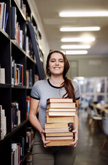 Woman, student with stack of books in library and research for project, studying and learn on...