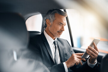 Tablet, business man and car for travel, journey or drive while reading email. Professional male person with tech for communication and internet connection for work with luxury transportation or taxi © Nikish H/peopleimages.com