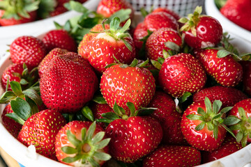 Red strawberries in white basket - close up