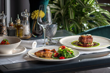 table setting with plate of beef with roasted chicken. copy space.