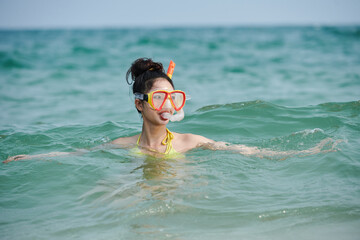 Young woman scuba diving in sea, summer vacation concept