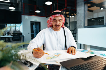 Young successful arab businessman working in the office