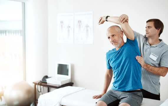 Stretching, physiotherapy and a man with doctor for physical therapy, fitness and health support. Healthcare, sports training and a physiotherapist with a senior patient and arm stretch after injury