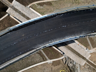 A newly built road, on the layer of which you can see successive layers of screed and asphalt...