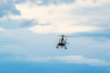 Fototapeta na wymiar Helicopter flying in the sky