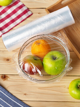 Bowl of fresh fruit in a glass bowl covered with cling film