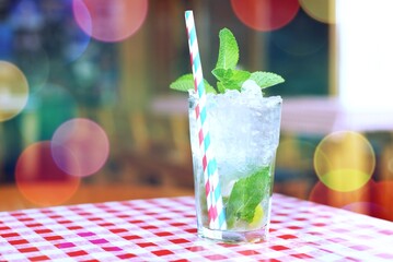 mojito cocktail with mint in bokeh lights