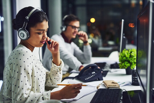 Call center, customer service and a woman at night, working in the office for consulting or assistance. CRM, contact us and support with a female consultant using a headset to help a client online