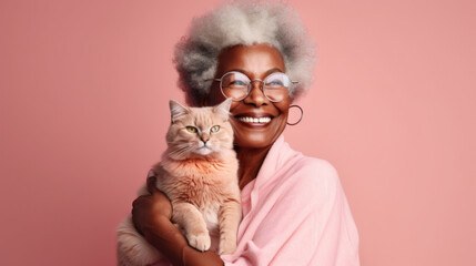 A joyful modern African American senior woman wears eyeglasses shares a tender hug with her pet cat in this captivating studio light pink background. Generative AI