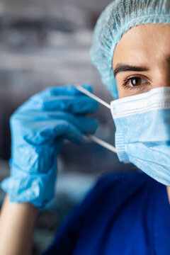 Close-up Of A Tired Nurse Removing Surgical Mask. Concept Of End Lockdown For Coronavirus