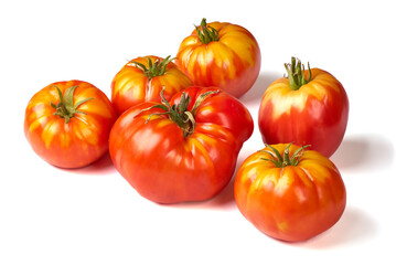 Colorful yellow and red tomatoes of different sizes and kinds isolated on white background.