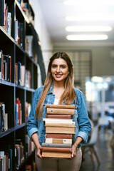 Woman, college student with stack of books in library and research with studying and learn on university campus. Female person smile in portrait, education and scholarship with reading material