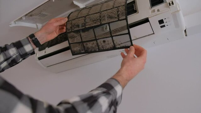 Air conditioner filter dusty. Preparation for maintenance and cleaning.
