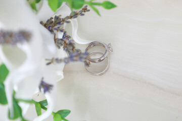 wedding rings on a white flower