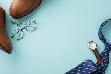 Classy Father's Day concept. Flat lay top view of silk necktie, leather shoes, wristwatch, spectacles, cufflinks, male accessories on pastel blue background with blank space for text or advertisement