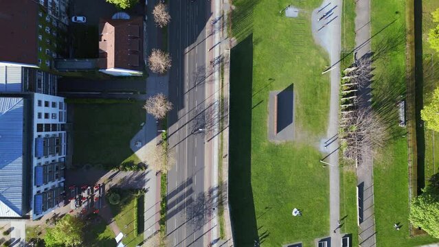 Long shadows, cycling road. Great aerial top view flight 
Berlin Wall Memorial Border crossing zone, city district Mitte, Germany spring 2023. vertical bird's eye view drone
4k uhd cinematic footage.
