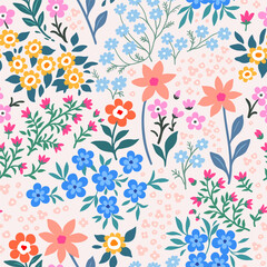 Seamless pattern. Vector flower design with cute wildflowers. Romantic abstract floral pattern on pale pink background. Illustrations of spring nature with red, blue and pink flowers.