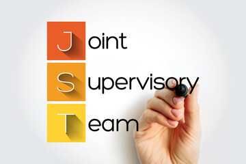 JST - Joint Supervisory Team acronym with marker, concept background