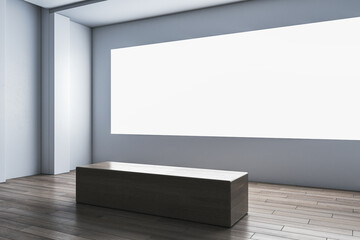 Perspective view on blank white illuminated screen with space for your advertising text or logo in abstract exhibition hall with grey wall background and bench on wooden floor. 3D rendering, mockup