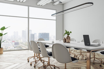 Perspective view on stylish white meeting table with golden legs and wheel chairs around on wooden floor and white wall background in sunlit conference area with city view backdrop. 3D rendering - obrazy, fototapety, plakaty