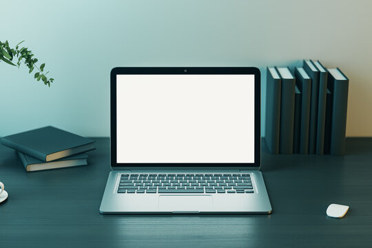 Front view on blank white modern laptop screen with place for web design, site or landing page on wooden table with black cover books and computer mouse on light wall background. 3D rendering, mockup