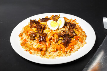Pilaf with salad and quail eggs, on a white plate, on an isolated white background