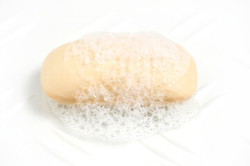 Fototapeta na wymiar Piece soaped toilet soap with foam white background.