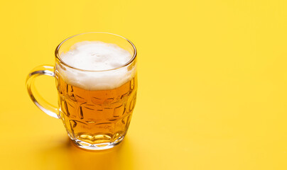 A cold beer on a bright yellow background
