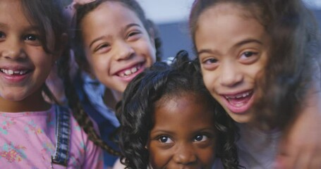 Diversity, portrait of a group of happy children and laughing with smiles on their face indoors. Development or happiness, community and cheerful or excited kids huddling in together for support