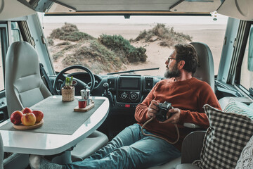Travel lifestyle and vanlife. Tourist enjoy and relax on vacation sitting inside motorhome vehicle...