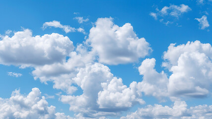 Naklejka na ściany i meble Blue sky filled with fluffy white clouds.