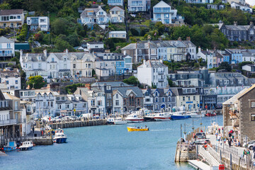 Fishing boats in the bay at Looe Harbour  and beach in Cornwall