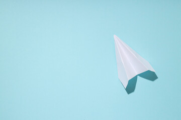 Business, startup and sponsorship concept with paper plane on blue background