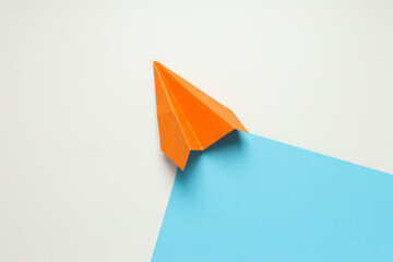 Orange paper plane on white - blue background © Atlas