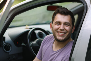 Man driving.First car.Driving school.Renting a car.Happy young man sitting in the auto.Happy moment.Traveling by car.Man smiling.boy with beard.
he sits in the car.Brutal man.
Ukrainian.Emotion.happy