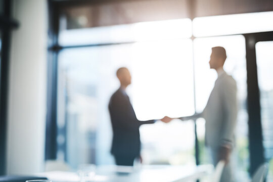 Business people, handshake and partnership for meeting, hiring or b2b deal agreement at office. Businessman shaking hands in recruiting, teamwork or collaboration with blurred background at workplace