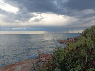 Fototapeta na wymiar Storm Clouds Over Cold Sea Water. Stylized panoramic seascape